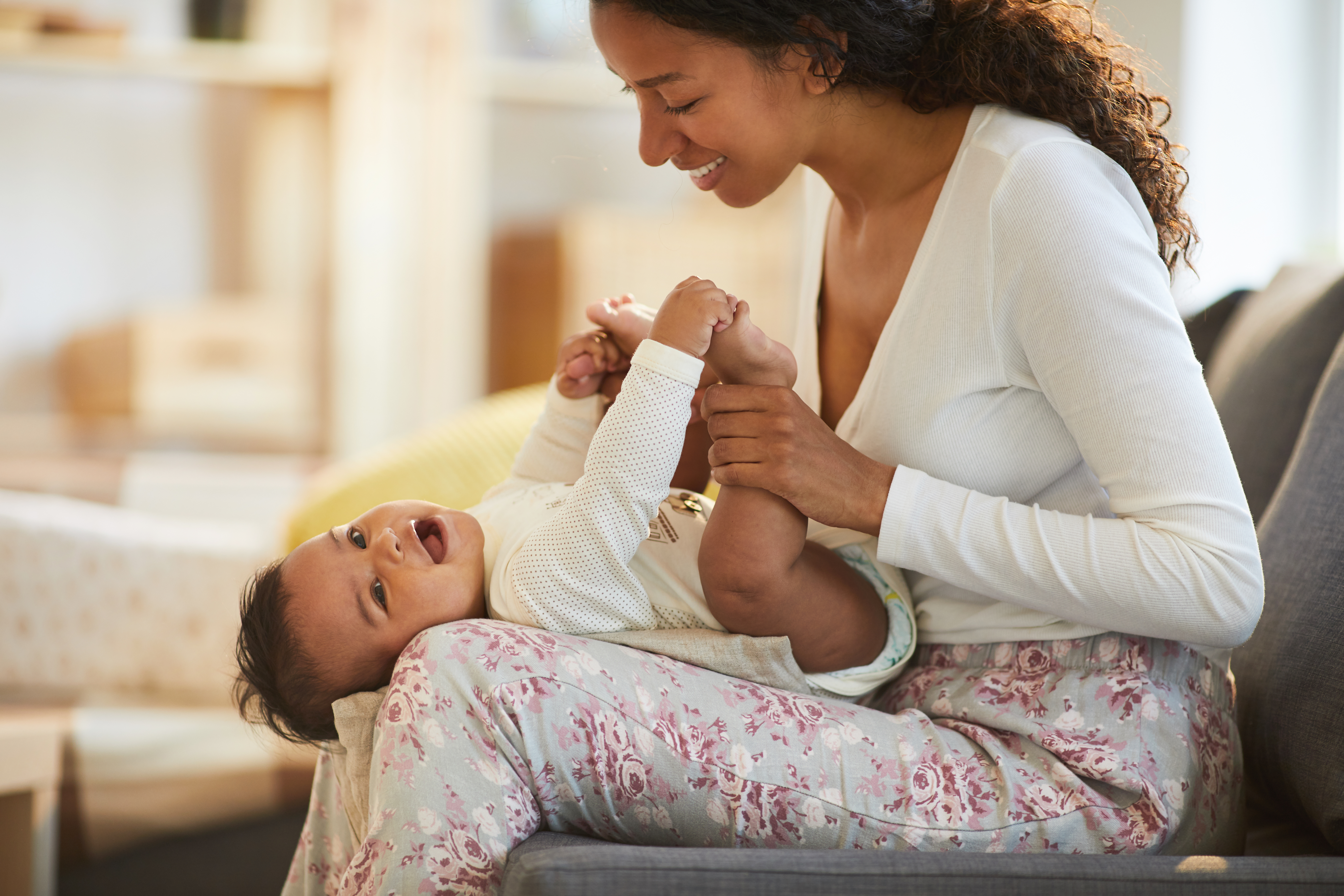 Black mother having fun with baby